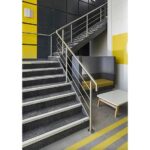 An office staircase featuring yellow accents and Warrior Stair Nosing 48MM Height 23MM Width ASN4823PVC made from ASN4823PVC.