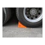 A Warrior truck with a Warrior PU Foam Wheel Chock Orange SWP-1A on top of an orange block.