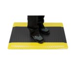 A Warrior standing on a yellow and black Warrior Rubber Anti Fatigue ESD Mat 60CM Width 90CM Length Black and Yellow WAFM-9060-B/Y.
