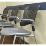 A row of chairs in a waiting room adorned with PVC Wall Strips.