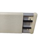 A white plastic shelf with a black handle, featuring a PVC End Cap for added durability.