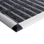 The Warrior Aluminium Entrance Mat 42CM Width 60CM Length Charcoal, adorned in bold charcoal tones, lays gracefully on a pristine white surface.